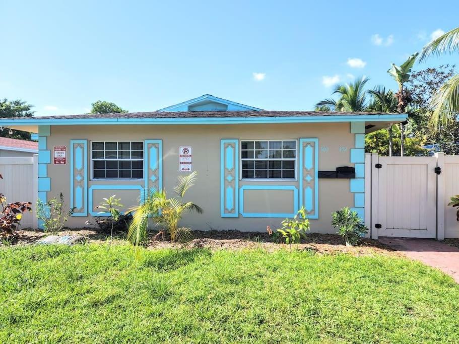 una casa con puertas azules y un patio en Stylish 2BR Villa full kitchen 10 mins from Beach, en Fort Lauderdale