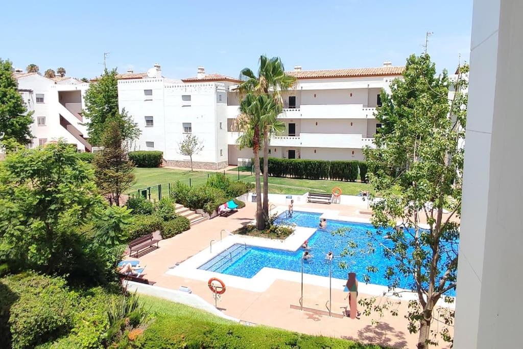 un appartement avec une piscine et un bâtiment dans l'établissement Acogedor Ático en El Mirador, à Alcaidesa
