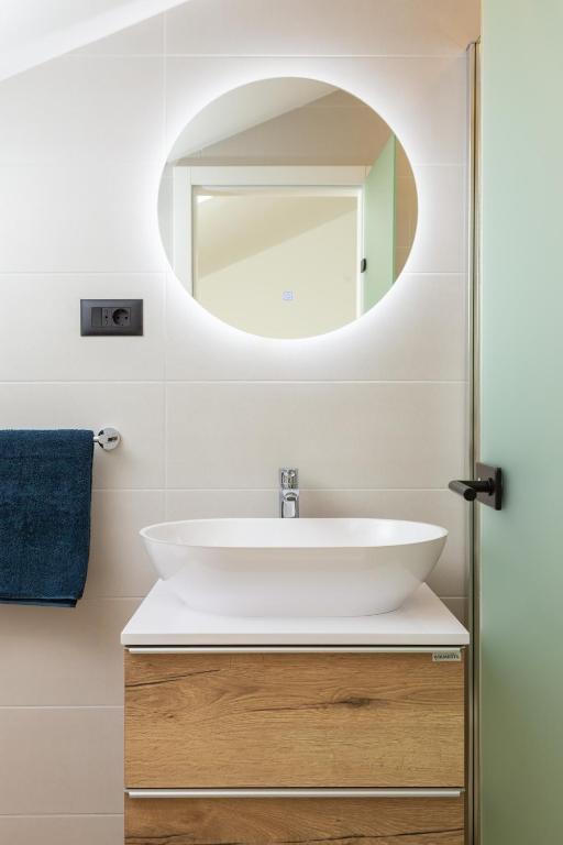 a bathroom with a sink and a mirror at Modern suite Beleca near Split in Solin