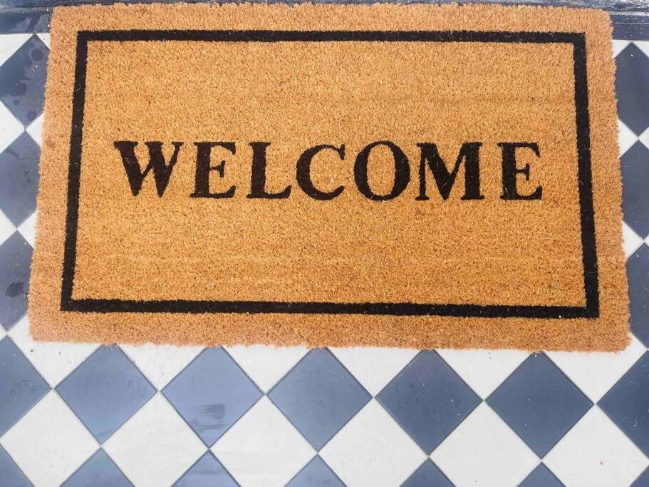 a sign with the word welcome on a table at NEW Camden Kentish Town garden London up to 4 ppl in London