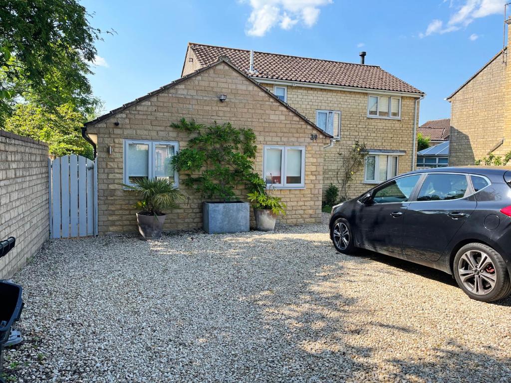 a car parked in front of a house at Self contained annex with full kitchen in Witney