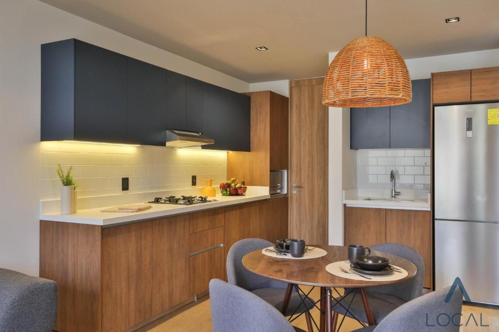 A furnished studio kitchen-diner with a round two-person table.