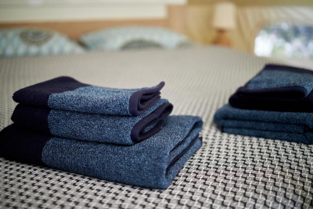 a pile of towels sitting on top of a bed at glamping Shangri la 
