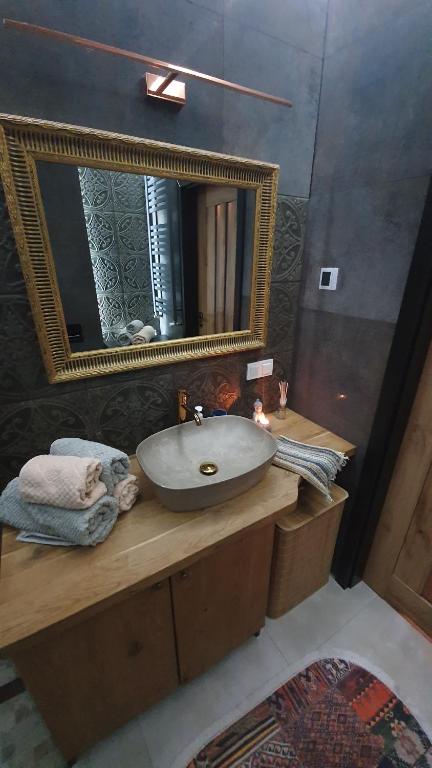ein Bad mit einem Waschbecken und einem Spiegel in der Unterkunft Apartment in city center in Przemyśl