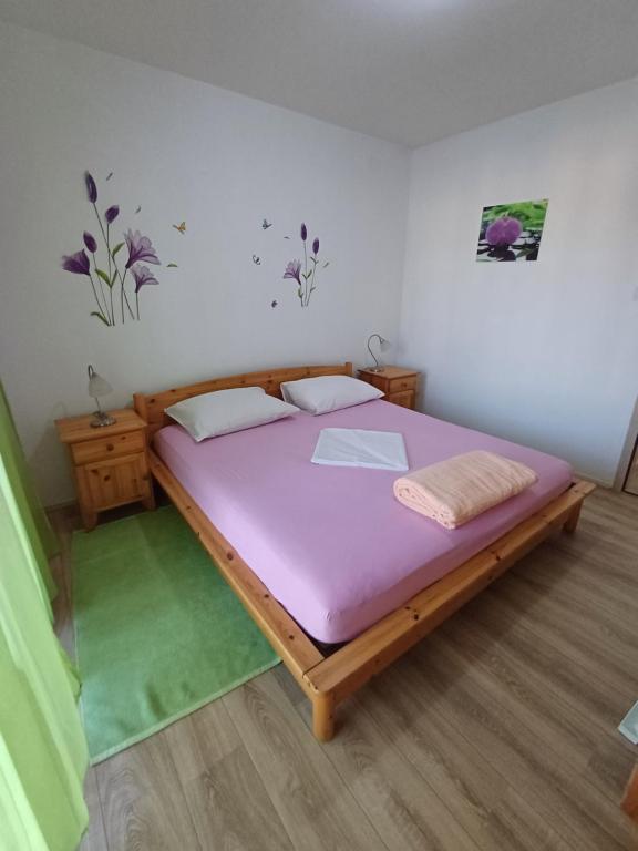 a bedroom with a large bed with a purple mattress at Apartments Lana in Pula
