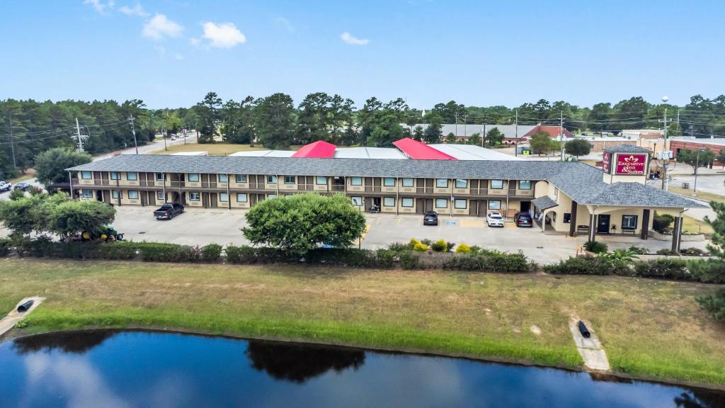an aerial view of a hotel with a parking lot at Executive Inn & Suites Magnolia in Magnolia