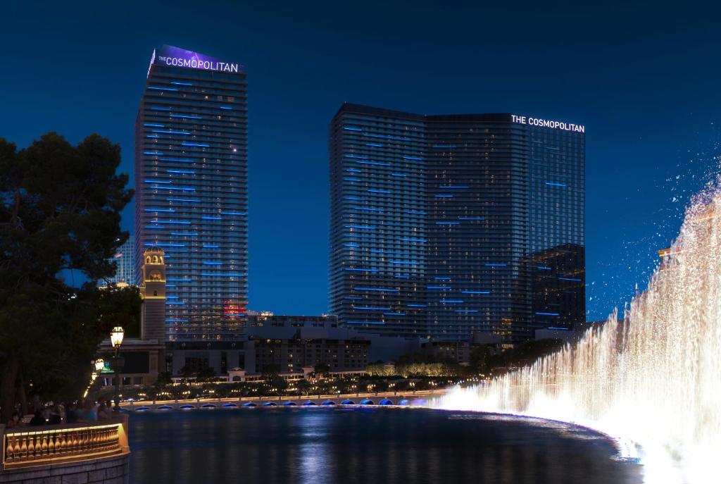 a fountain in front of a city with tall buildings at The Cosmopolitan Of Las Vegas in Las Vegas