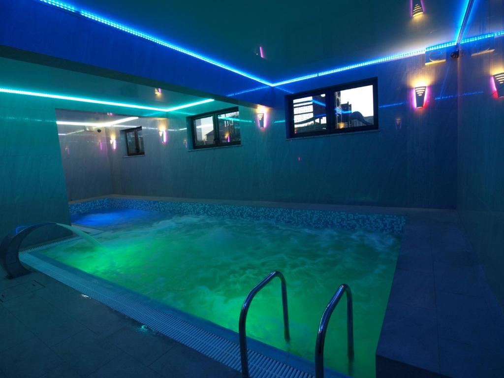 a large swimming pool with blue and green lights at Avena in Jastrzębia Góra