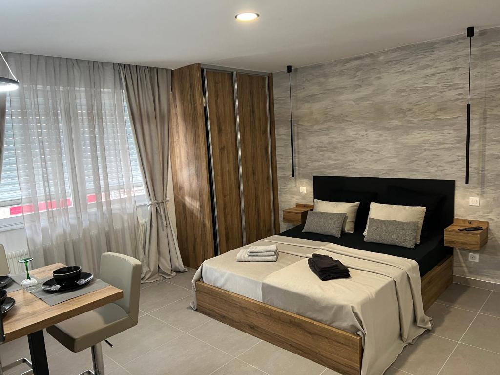 1 dormitorio con cama, mesa y escritorio en MISIC HOME, en Colmar