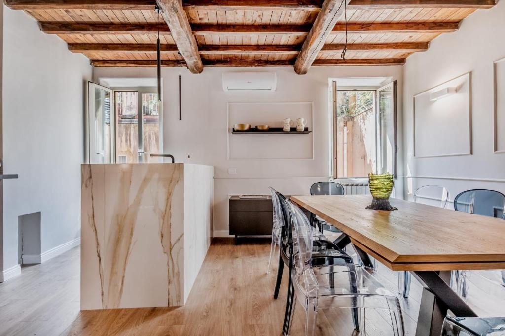 a dining room with a wooden table and chairs at APT ROME - Vittoria Palace in Rome