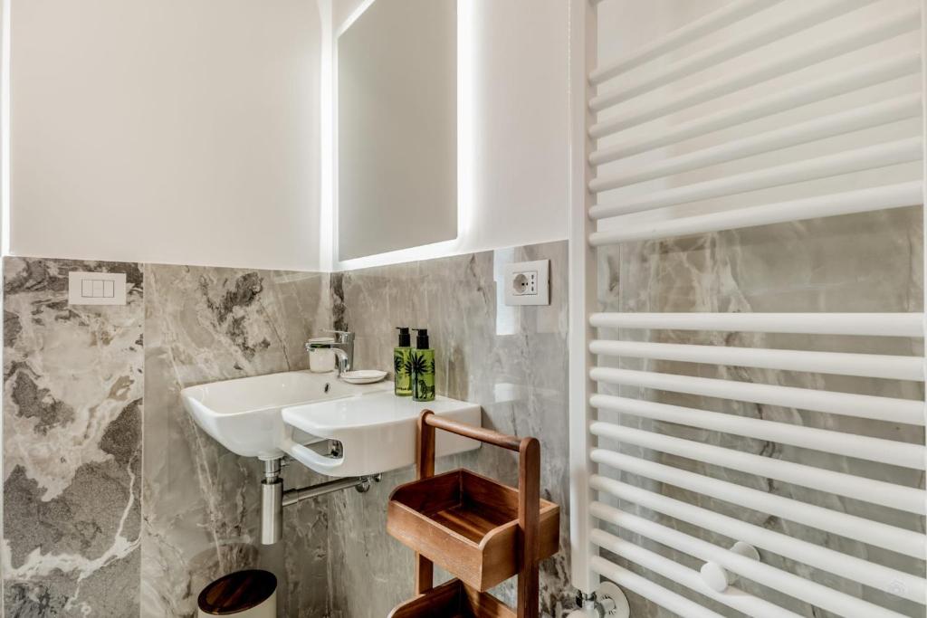 a bathroom with a sink and a mirror at APT ROME - Vittoria Palace in Rome