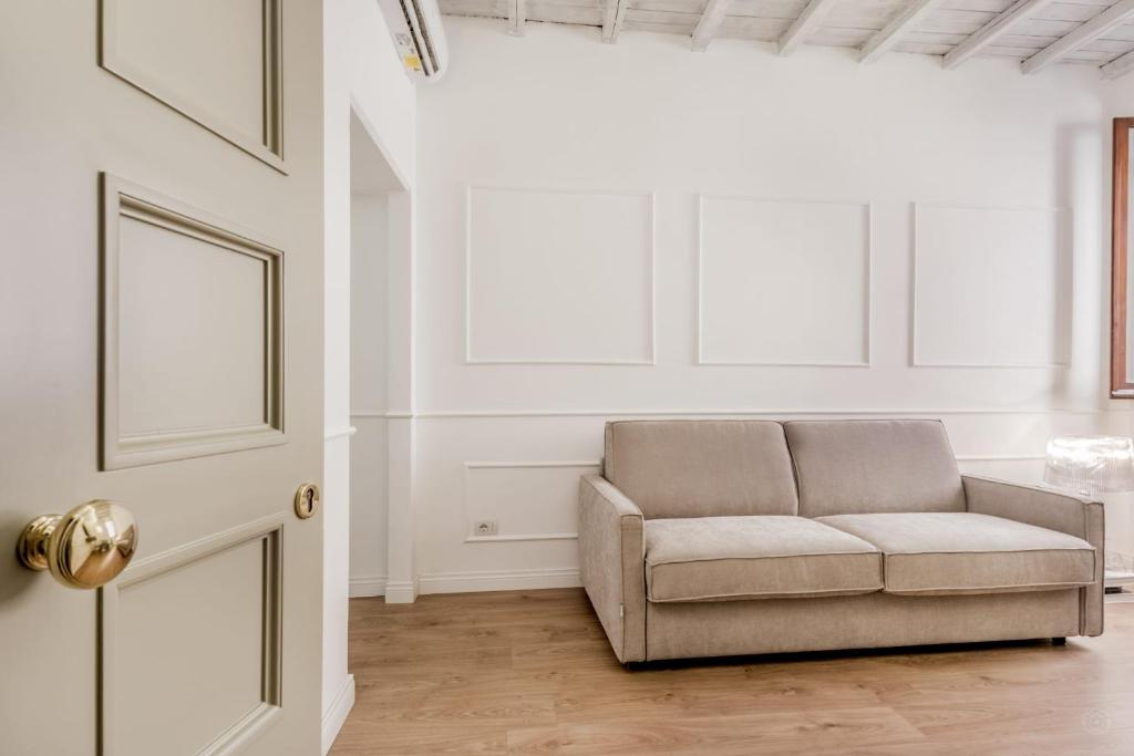 a living room with a couch and a door at APT ROME - Vittoria Palace in Rome