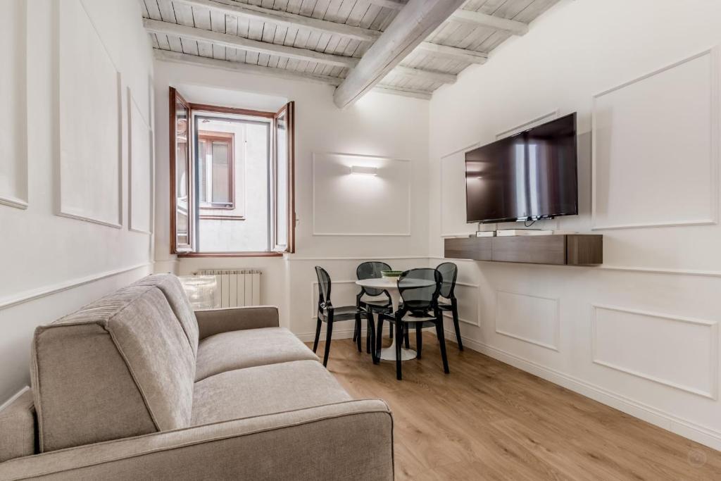 a living room with a couch and a table at APT ROME - Vittoria Palace in Rome