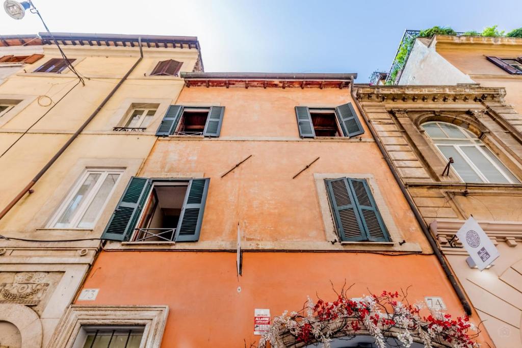 a tall building with windows and flowers on it at APT ROME - Vittoria Palace in Rome
