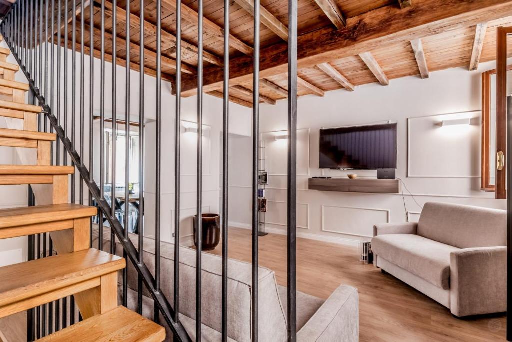 a living room with a staircase and a couch at APT ROME - Vittoria Palace in Rome