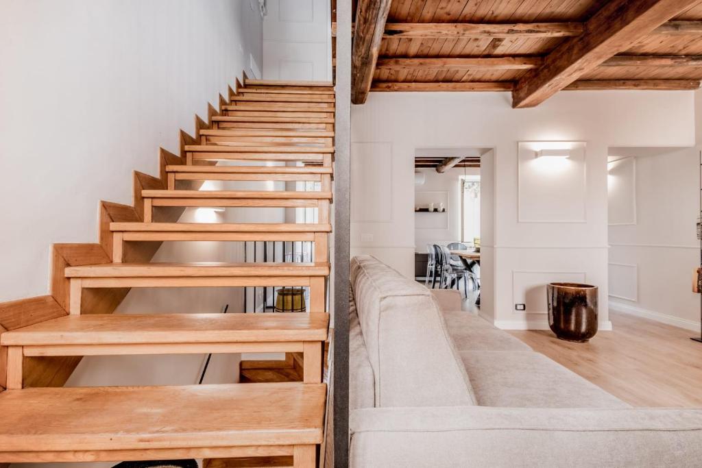 a staircase in a room with white walls and wooden ceilings at APT ROME - Vittoria Palace in Rome