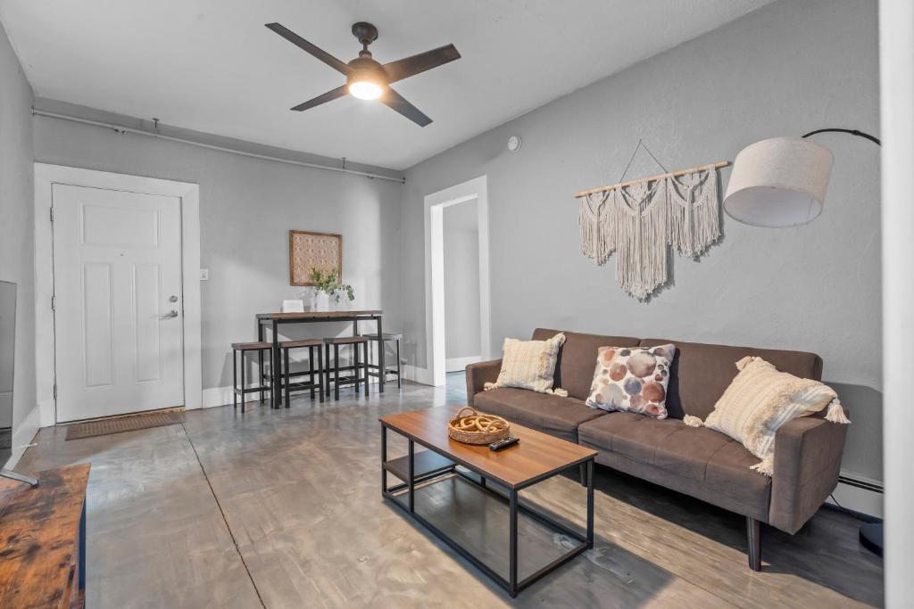 a living room with a couch and a table at Navarre Apartments in Des Moines