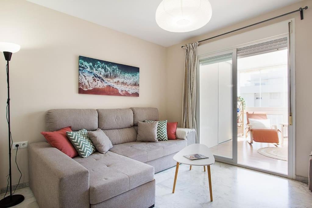 a living room with a couch and a table at Great location! Walking distance to everything! in Fuengirola