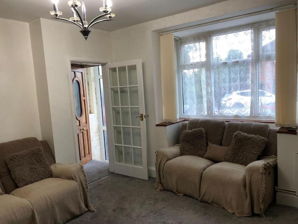 a living room with two couches and a window at Holiday inn house in Longton