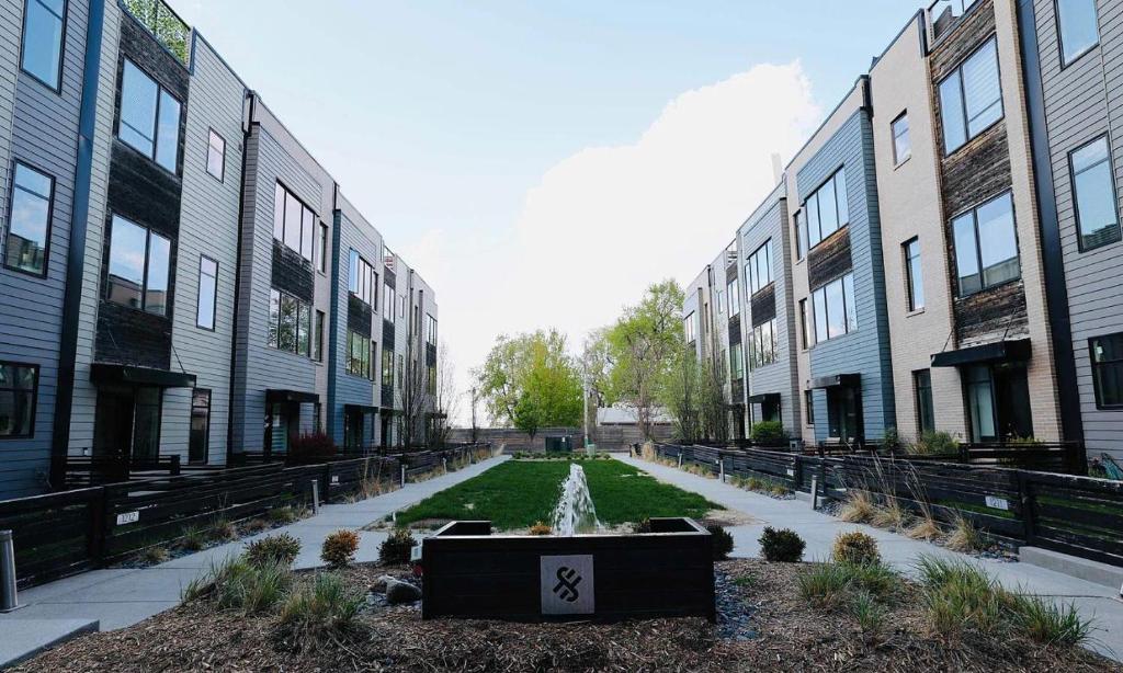 a courtyard with a fountain in front of some buildings at Modern Townhome Near Downtown walk to CWS! in Omaha