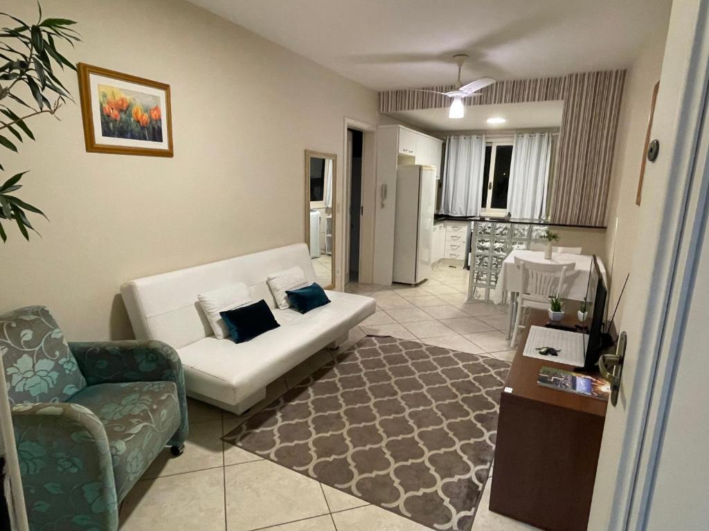a living room with a couch and a table at Apto Centro Catedral in Santa Cruz do Sul