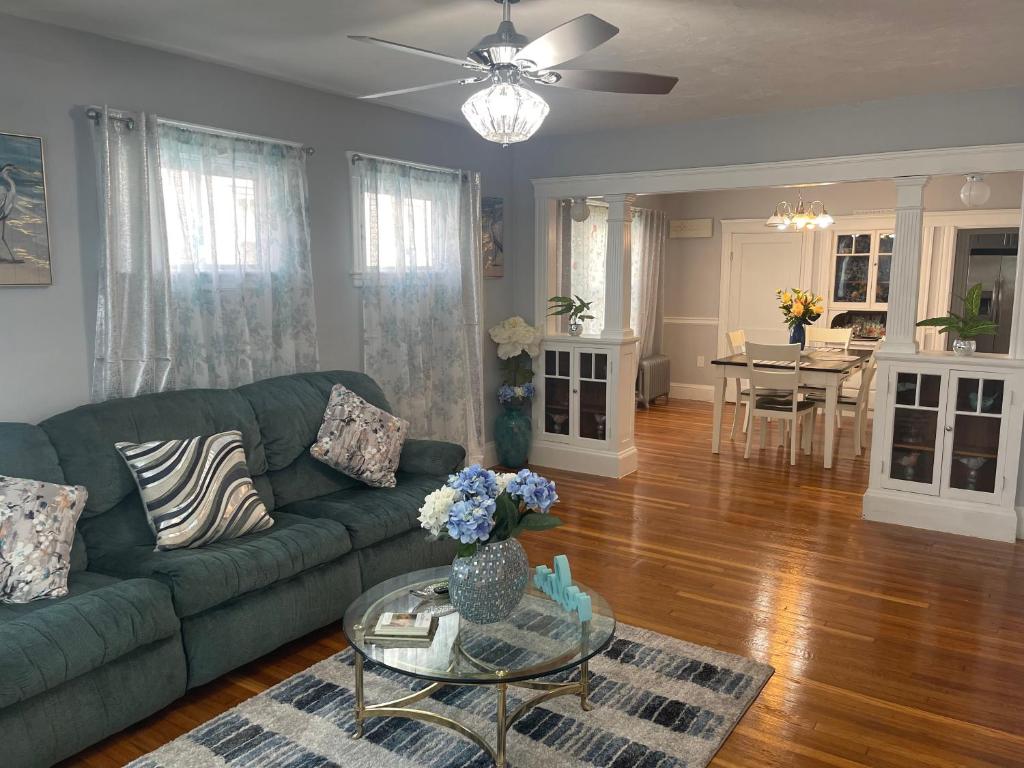 a living room with a green couch and a table at Boston Luxury 2 Bedroom Private Condo in Boston