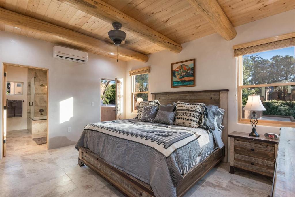 a bedroom with a bed and a wooden ceiling at Linda - Walk to The Plaza in Santa Fe