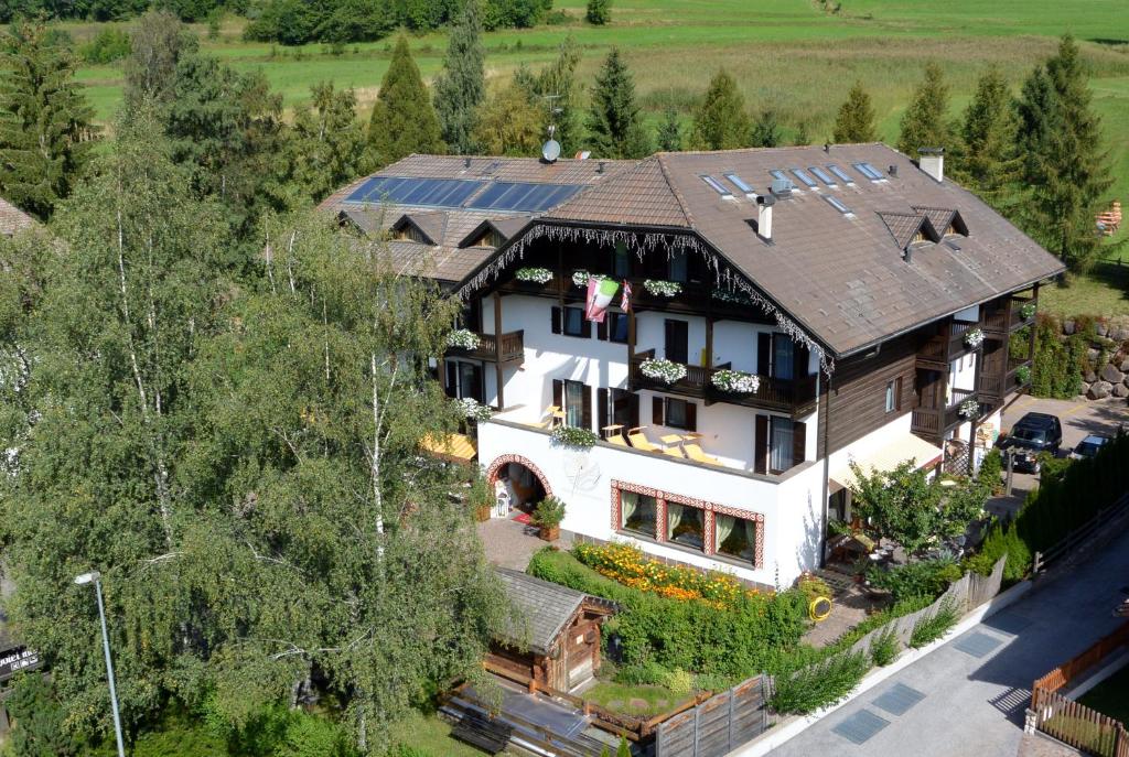 an aerial view of a house with a solar roof at Beauty & Vital Hotel Maria in Carano