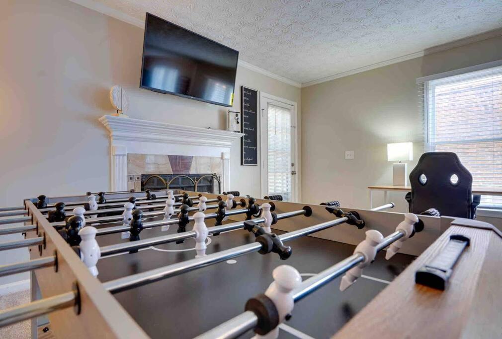 a large room with a pool table and a fire place at Peace and Games with Class in Stone Mountain