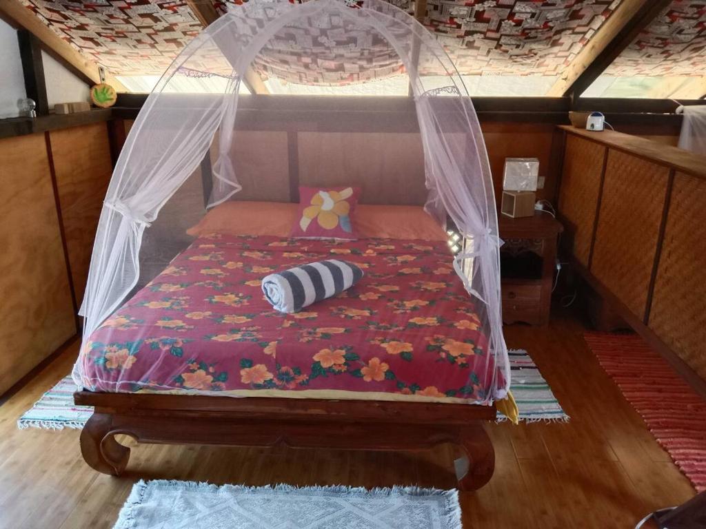 Postel nebo postele na pokoji v ubytování Chalet chez Téra'i