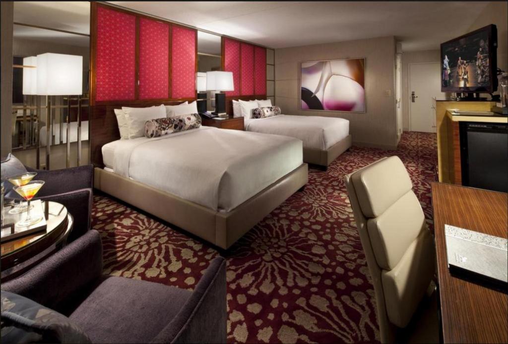 a hotel room with two beds and a television at Charming Unit at MGM Grand STRIP Las Vegas in Las Vegas