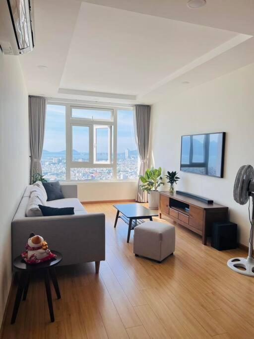 a living room with a couch and a table at ChouChou Apartment in Danang