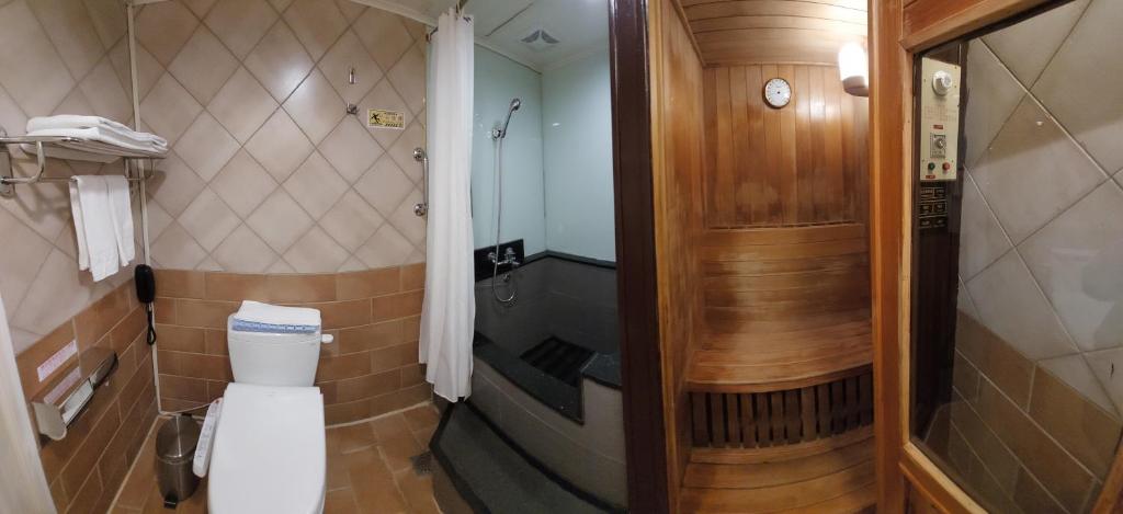a bathroom with a toilet and a walk in shower at Yomi Hotel - ShuangLian MRT in Taipei