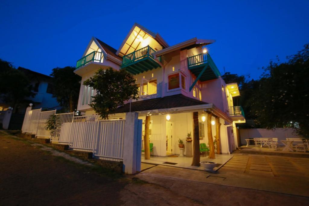 a large house with lights on it at night at Ceylon House By Sunrise in Ella