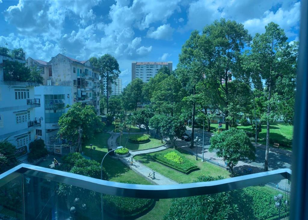 a view of a park from a balcony at Brand New Cozy Home in D1 wBalcony in Ho Chi Minh City