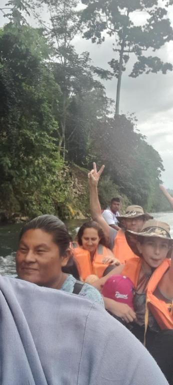 a group of people on a raft in a river at Lodging and Adventure in Soposo