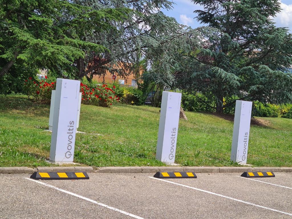 a parking lot with white signs in the grass at Campanile Saint-Etienne Est- Saint-Chamond in Saint-Chamond