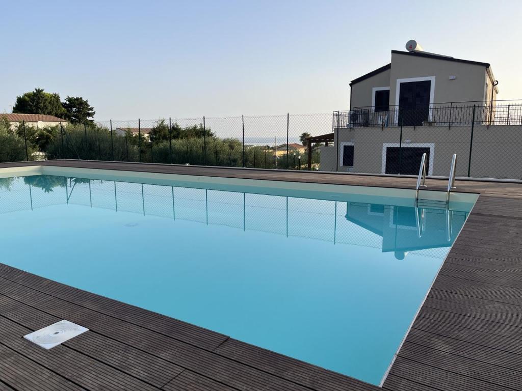a swimming pool in front of a house at Villa Simo in Altavilla Milicia