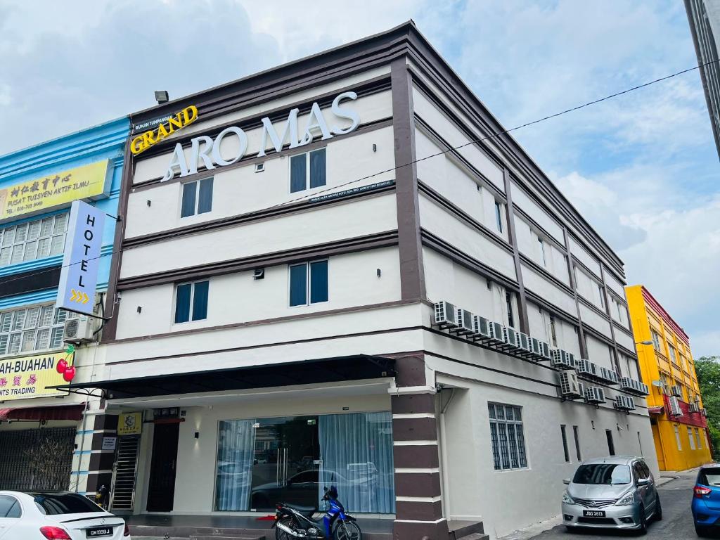 a building with a sign on the front of it at GRAND AROMAS in Kulai