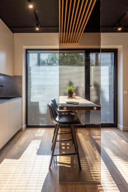 a kitchen with a table and a chair in a room at Palanga Studios in Palanga