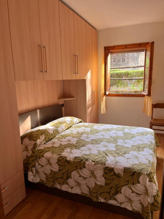 a bedroom with a bed and a window in it at La Casina di Checco in Marciana Marina