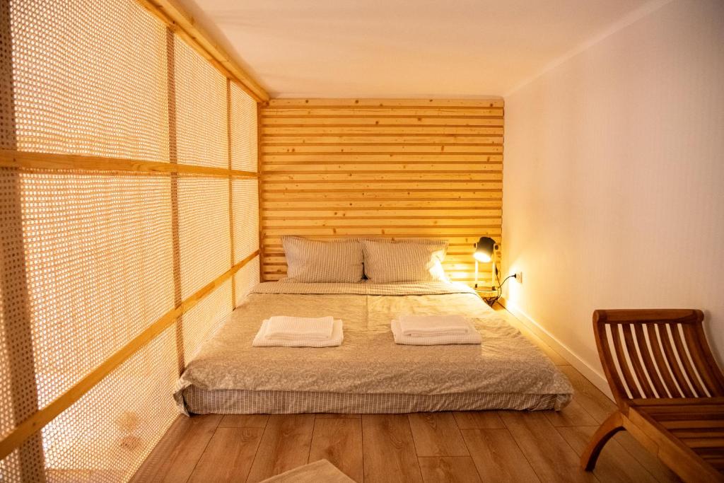 a bedroom with a bed with a wooden headboard at Yellow studio in Cluj-Napoca
