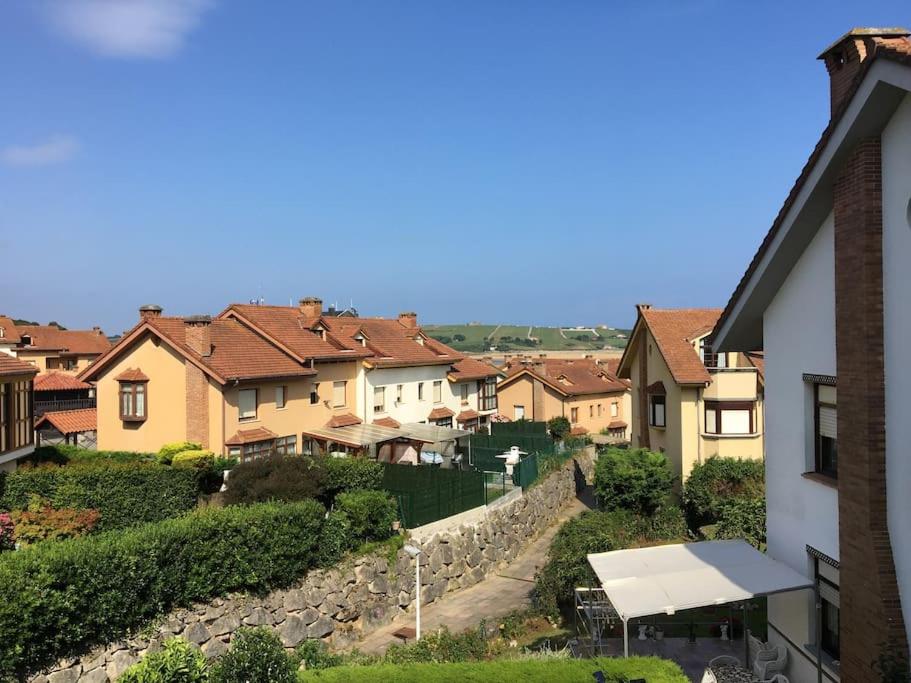 a group of houses and a stone wall at Apartamento Playa de Usil in Mogro