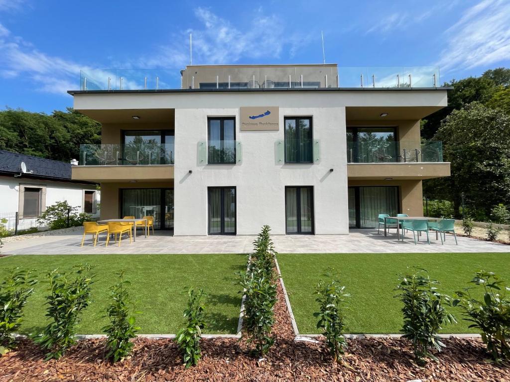 a house with a lawn in front of it at Optimus Residence in Balatonföldvár