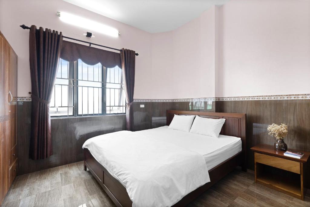 Postel nebo postele na pokoji v ubytování Mộc Nhiên Hotel Da Nang
