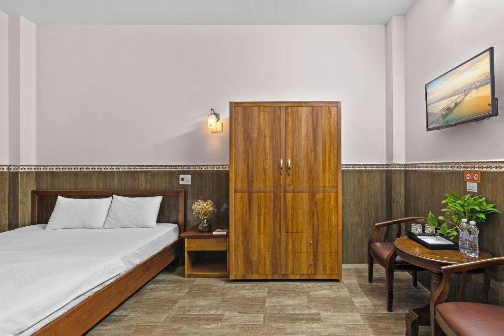 Postel nebo postele na pokoji v ubytování Mộc Nhiên Hotel Da Nang
