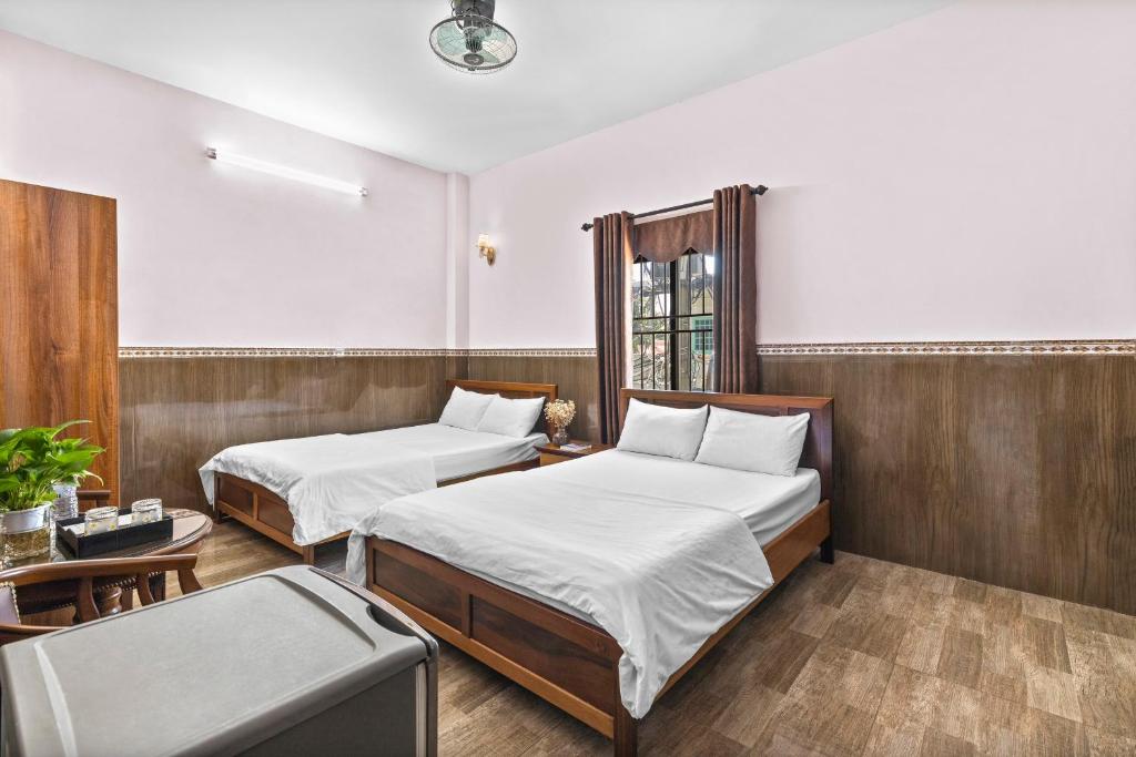 Postel nebo postele na pokoji v ubytování Mộc Nhiên Hotel Da Nang