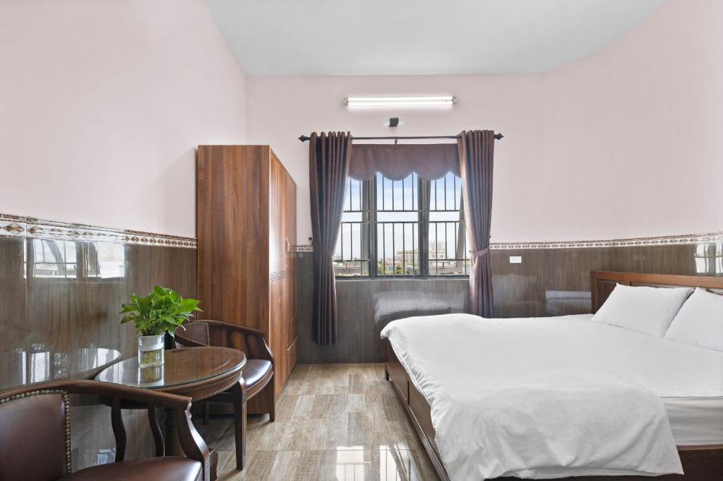 Postel nebo postele na pokoji v ubytování Mộc Nhiên Hotel Da Nang