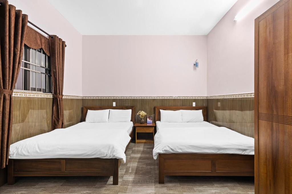 Postel nebo postele na pokoji v ubytování Mộc Nhiên Hotel Da Nang