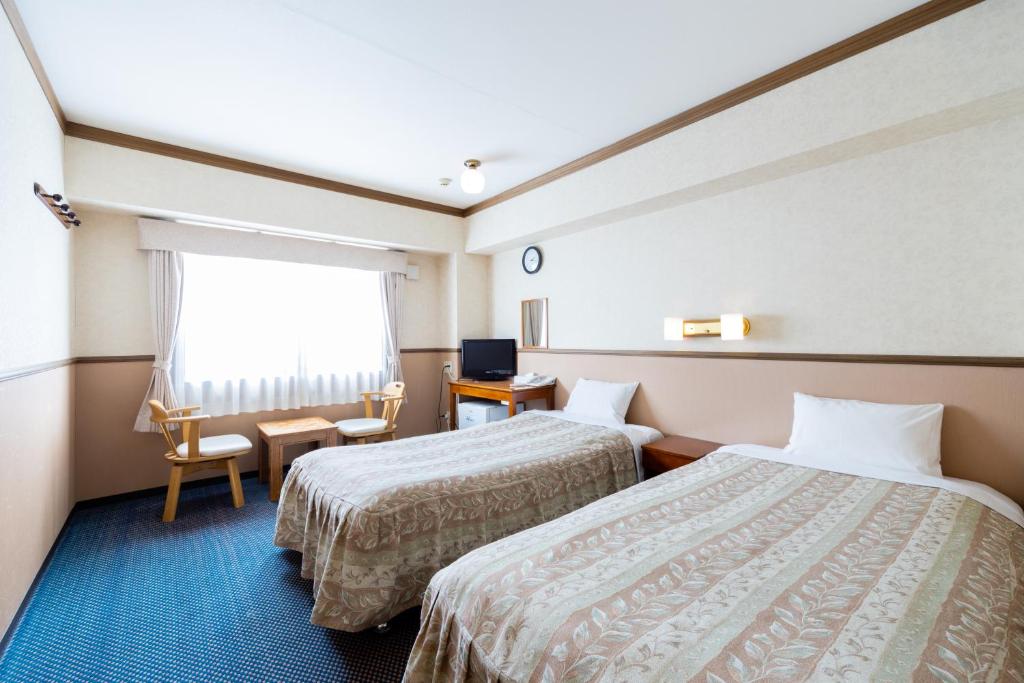 Postel nebo postele na pokoji v ubytování Gora Hotel Paipuno Kemuri Plus